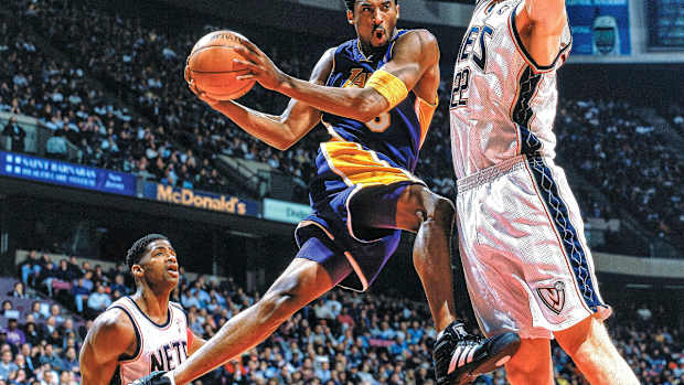 Kobe Bryant holding a basketball in mid-air